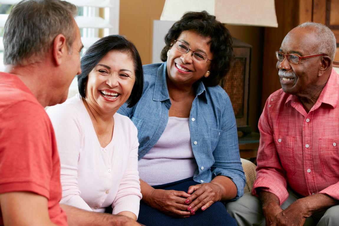 ENT Diagnosing Earwax Removal group of adults smiling and conversting with each other